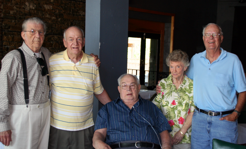 Kate Miller with the author's father (seated) and their high-school classmates